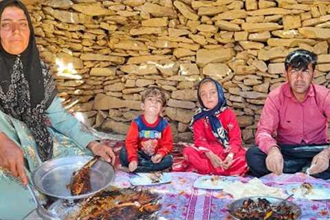 A nomadic woman cooked fish traditionally for her family